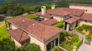 Elevated view of an elaborate Spanish inspired roof design cladded in orange, brown and red multi-tone clay roofing tiles installed by Schulte Roofing.