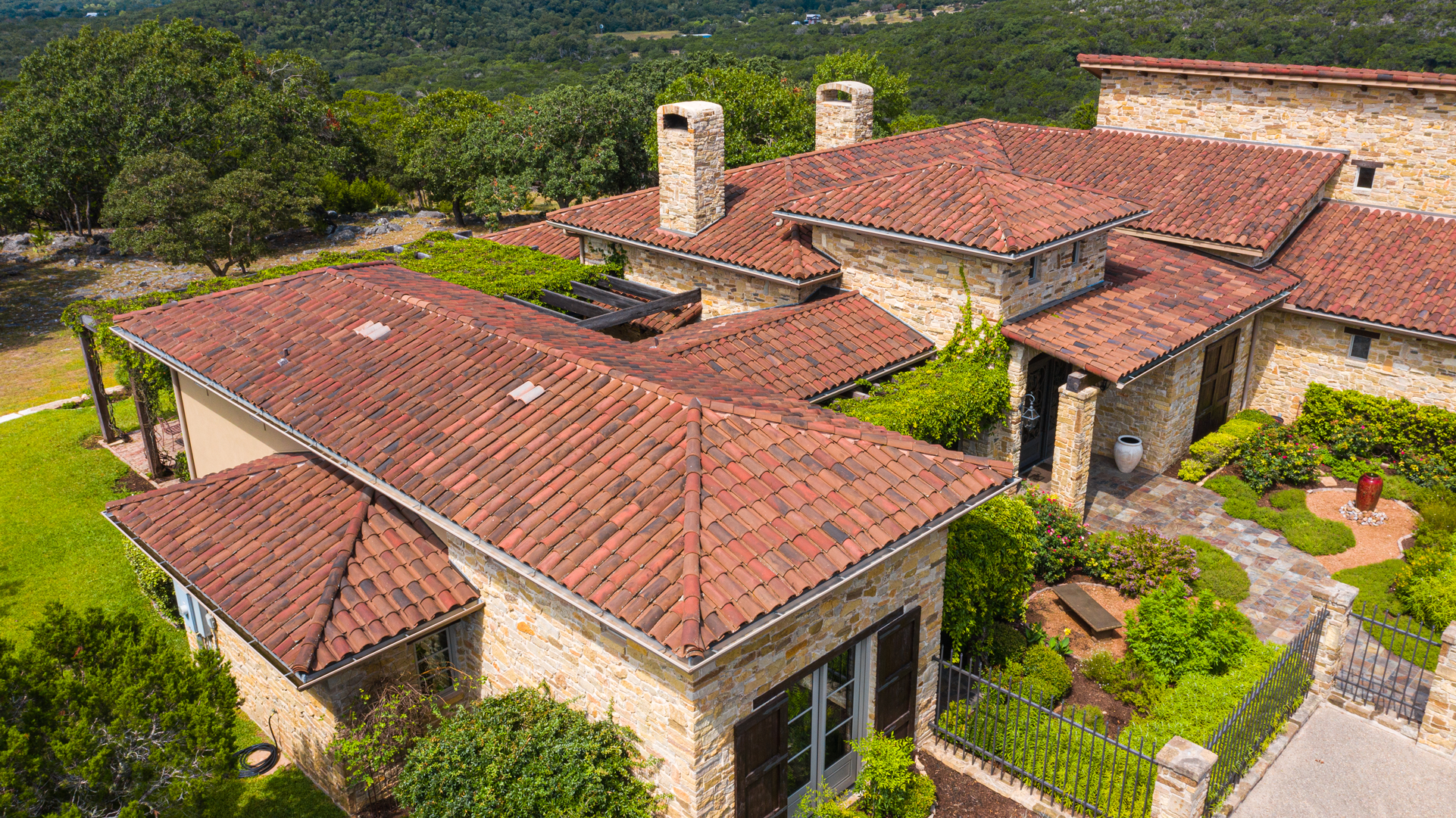 Detailed view of the clay tile arrangement on a residential roof, installed by Schulte Roofing in Ingram, Texas.