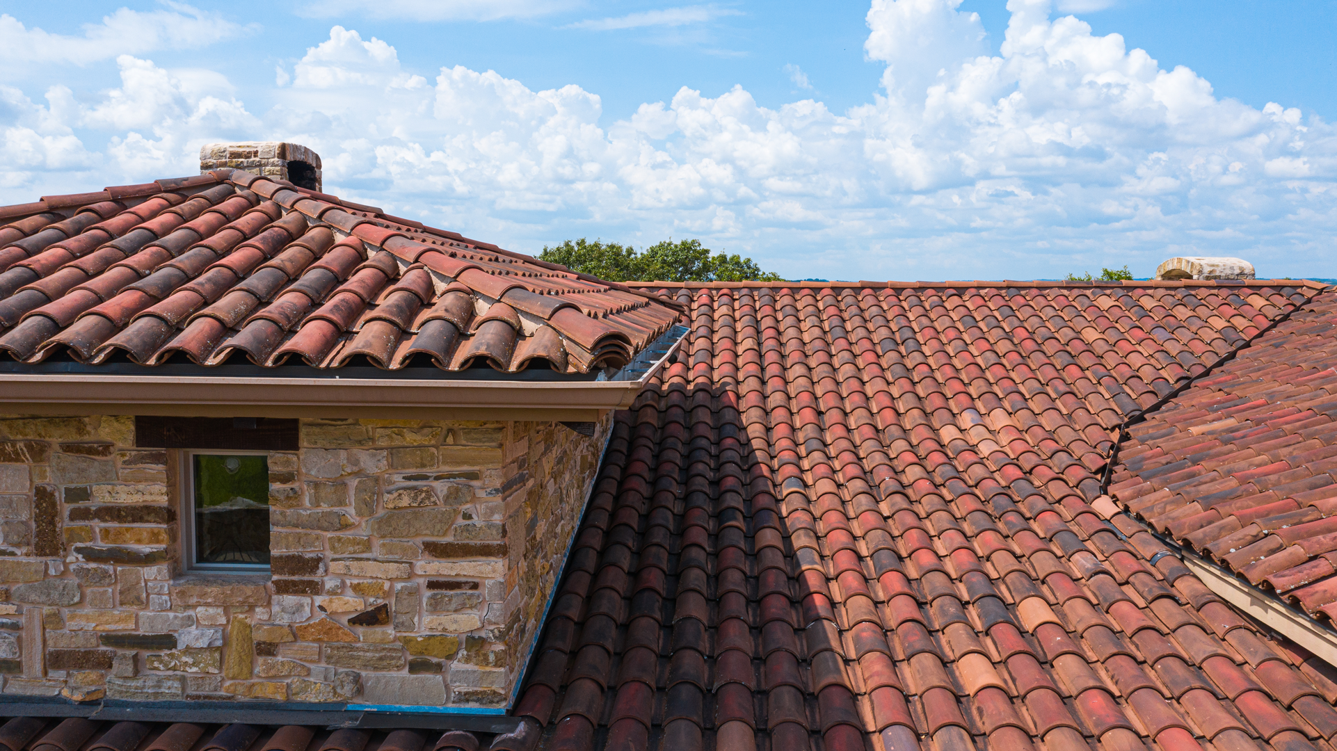 Close-up of the handmade clay tile roof details on a home in Ingram, Texas, highlighting the craftsmanship by Schulte Roofing.