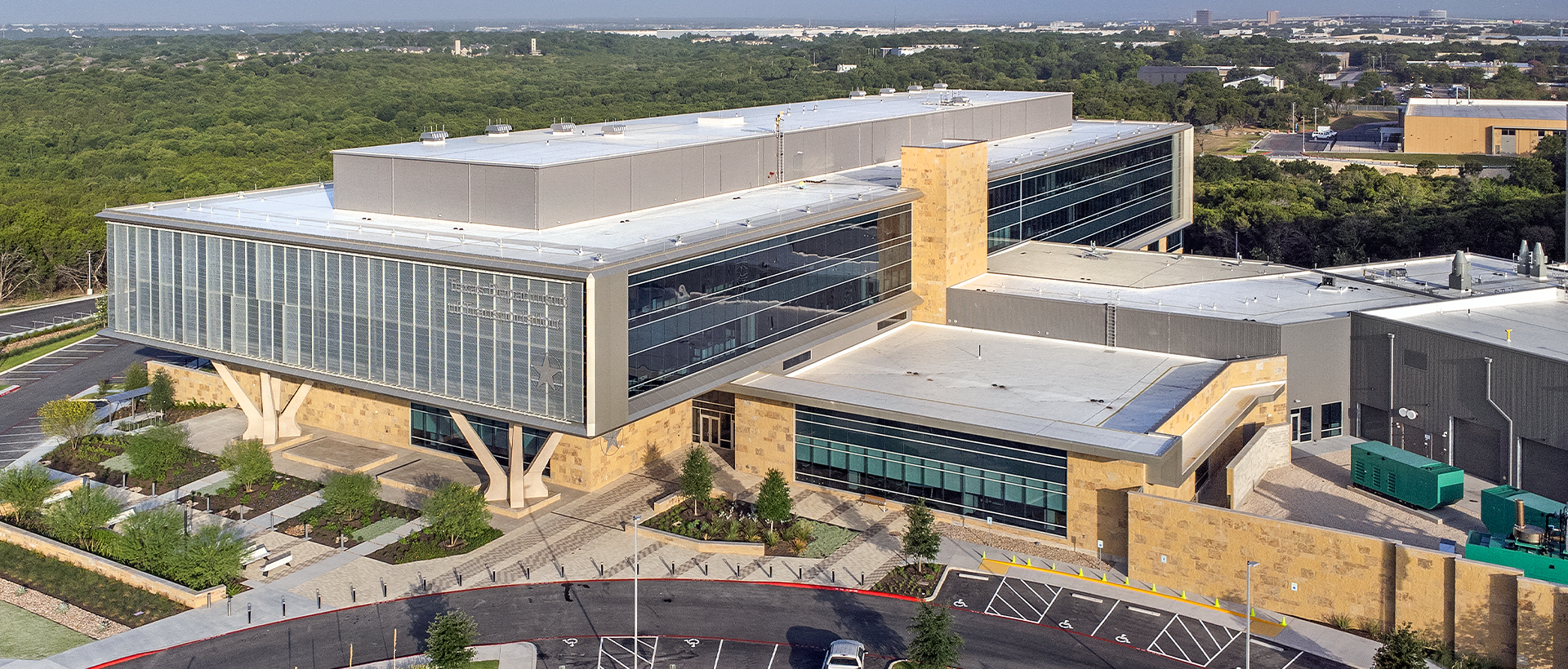 Texas Department of Public Safety's finished commercial flat roof by Schulte Roofing with view of the entire building and parking lot.